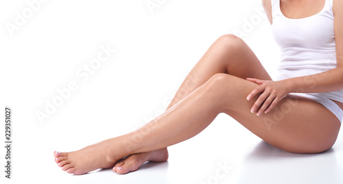 Legs of a beautiful girl on a white background
