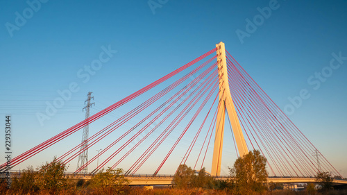 Suspension bridge over the Martwa Wisla in Gdansk at sunset.