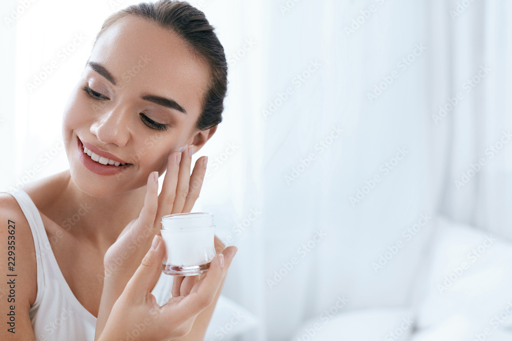 Beauty Skin Care. Beautiful Woman Applying Cream On Face Skin Beauty Skin Care. Beautiful Woman Applying Cream On Face Skin