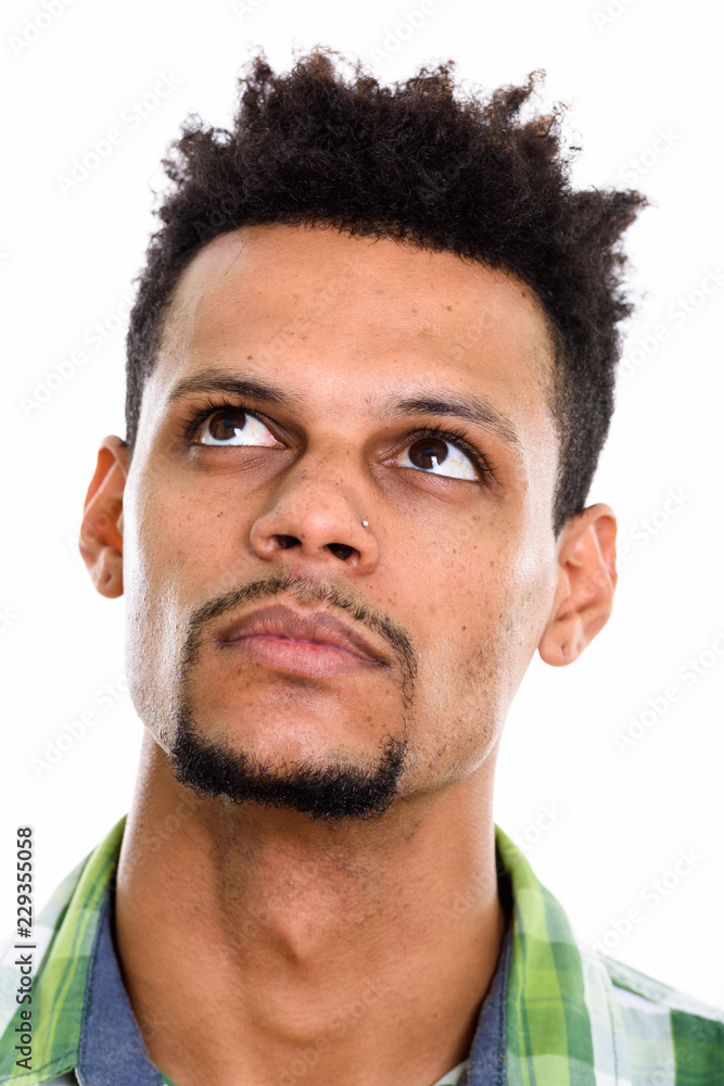 Obraz premium Face of young African man thinking while looking up