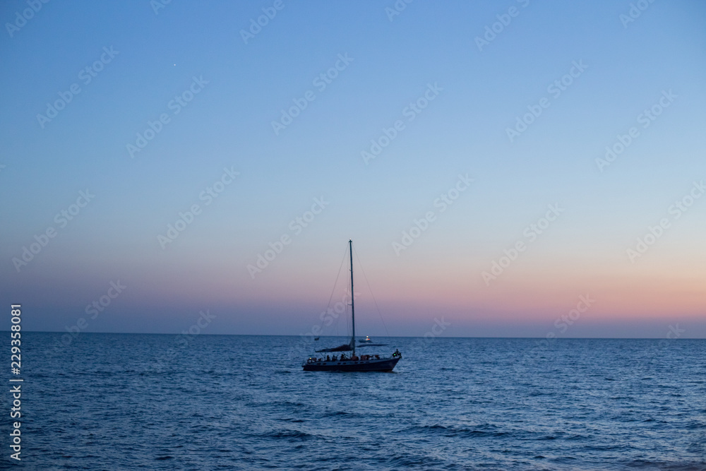 Sailing yacht at sea at sunset
