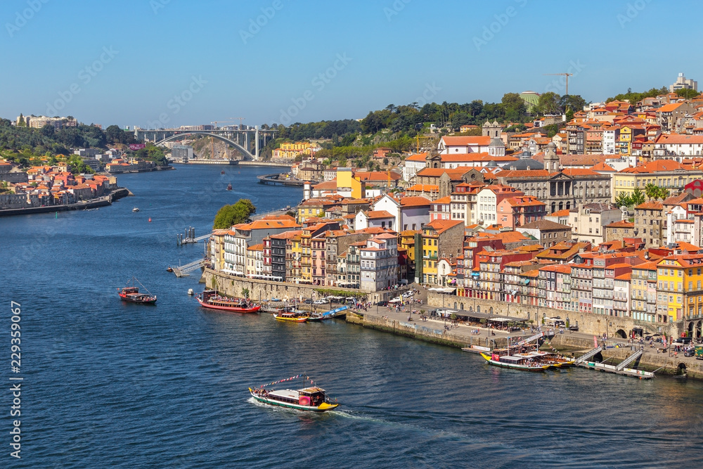 Traditional boats with barrels of wine, on the Douro River in the Portuguese city of Porto.