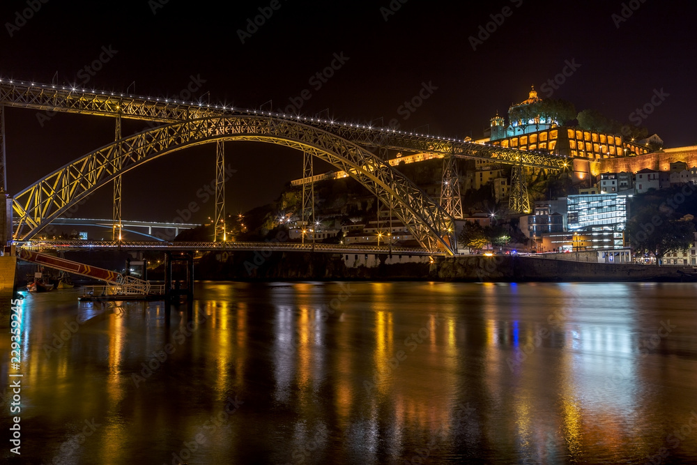 Night landscape of the city of Porto on the Douro River, overlooking the bridge of San Luis and the monastery.