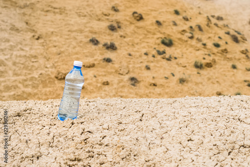 Bottle of clean drinking water in a dry desert