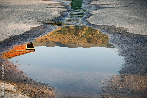 Photo Image reflected in a puddle