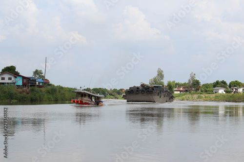 The ship is towed on the river.