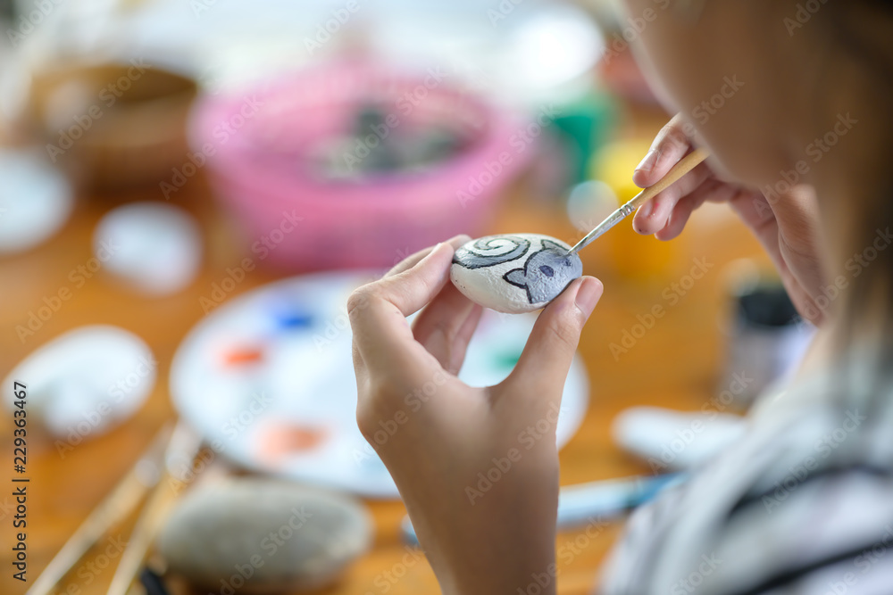 Cropped shot of young girl artist painting with water colour on rock. Cropped shot of young girl artist painting with water colour on rock.