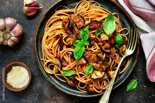 Spaghetti alla norma - traditional italian pasta with eggplants and tomato. Top view.
