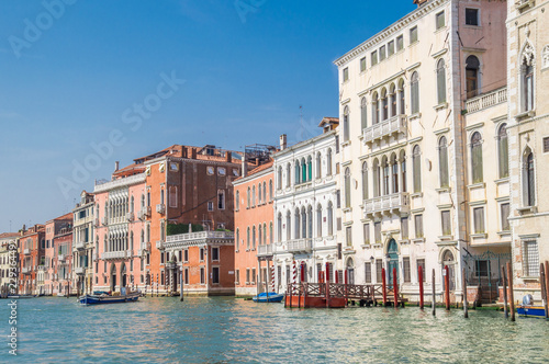Residential buildings along the embankment of the Grand Canal. In the background, blue cloudless sky.