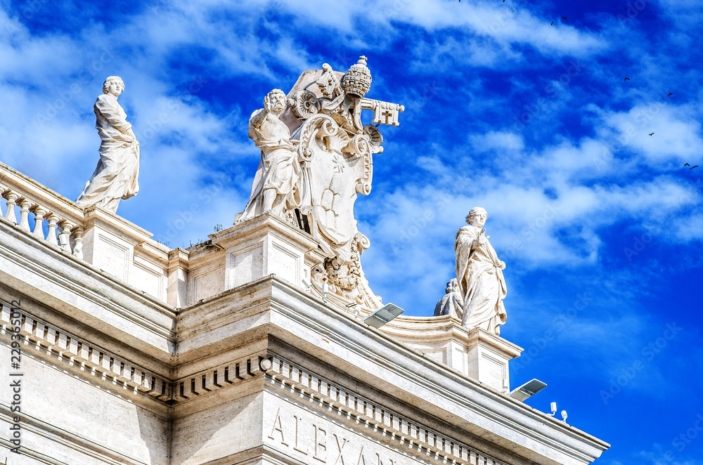 Statues on the Basilica of St. Peter against the blue sky. Vatican
