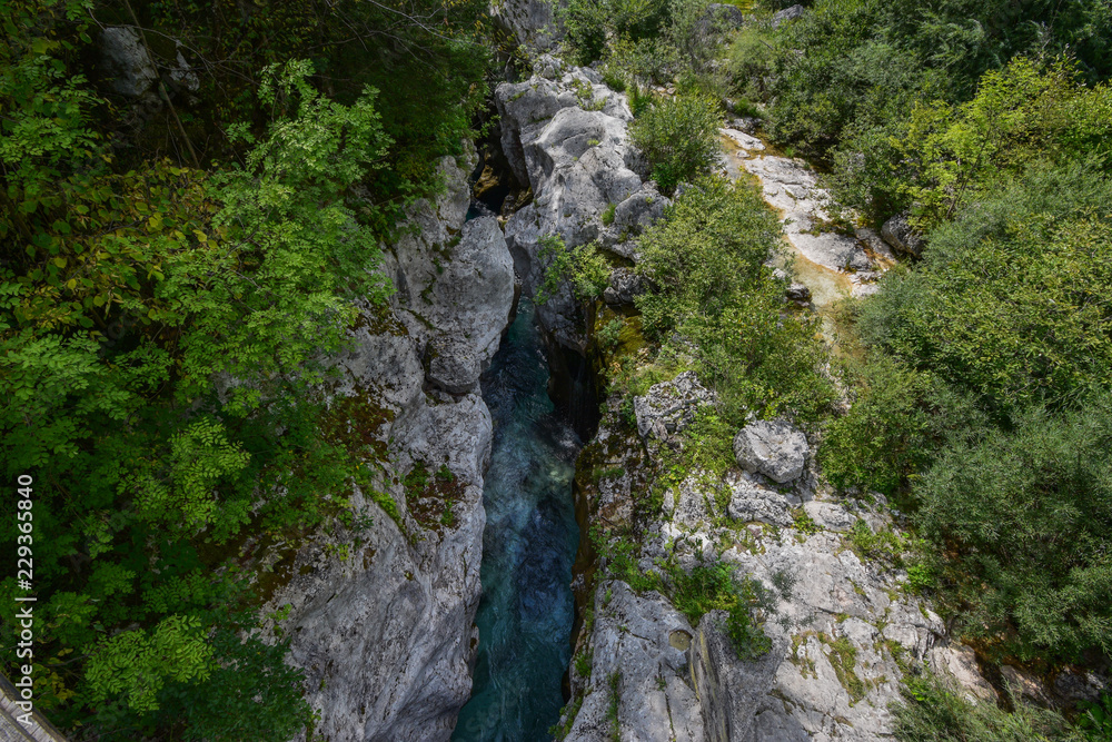 Just above Lepena Valley close to Bovec the Soča (Isonzo) River has carved 750 meters long gorge named Velika Korita. The gorge is completely narrow at some points up to 15 m deep. Just above Lepena Valley close to Bovec the Soča (Isonzo) River has carved 750 meters long gorge named Velika Korita. The gorge is completely narrow at some points up to 15 m deep.