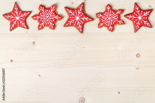 christmas homemade gingerbread cookies on wooden background with empty copy space for text. snowflake and star shapes. holiday, celebration and cooking concept. new year and christmas frame