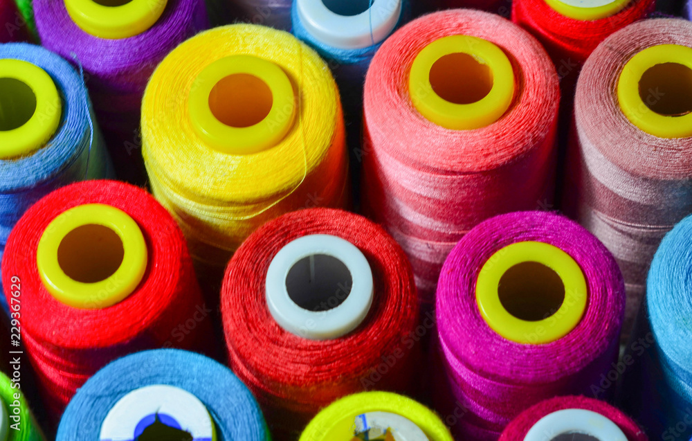 Sewing threads as a multicolored background closeup Sewing threads as a multicolored background closeup
