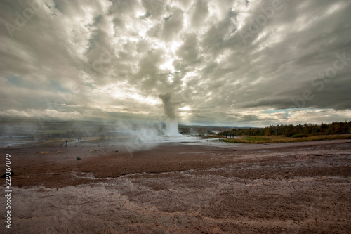 Strokkur (churn) fountain geyser in the geothermal area beside the Hvítá River. Haukadalur, Geysir - Iceland