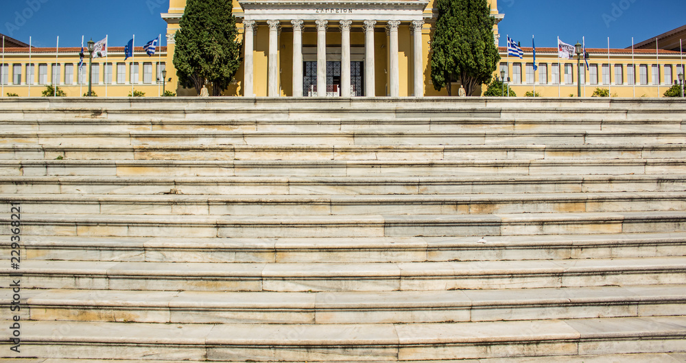 Fototapeta premium symmetry Greece marble palace front facade on blue sky background and stairs foreground
