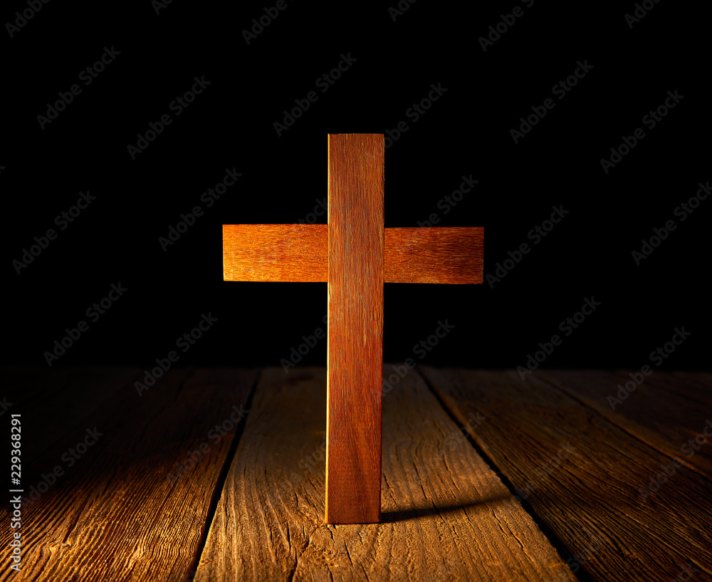 Christian wood cross on black background