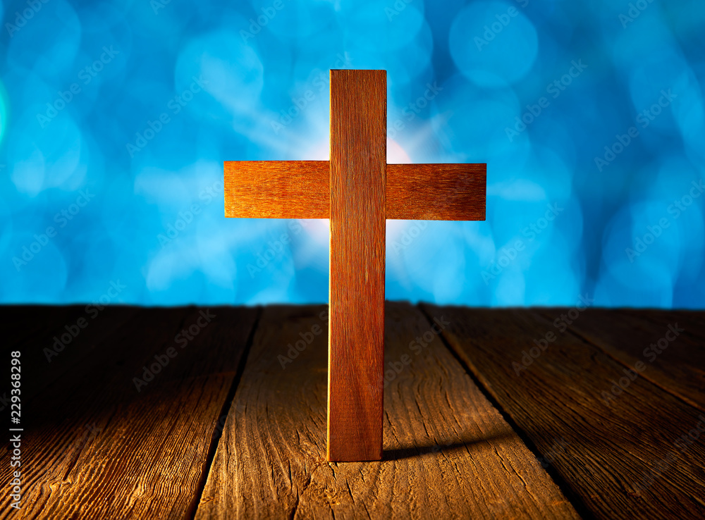 Christian wood cross on blue flare lights