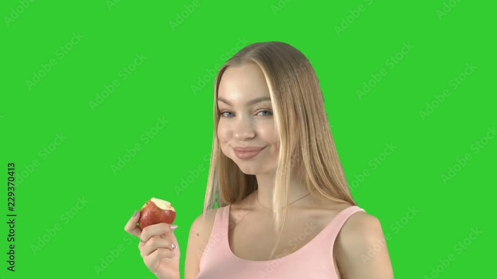Pretty young woman with an apple, isolated Pretty young woman with an apple, isolated