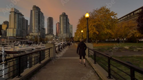 Wallpaper Mural A  lady walking by the coal harbour vancouver canada on a early morning fall day Torontodigital.ca