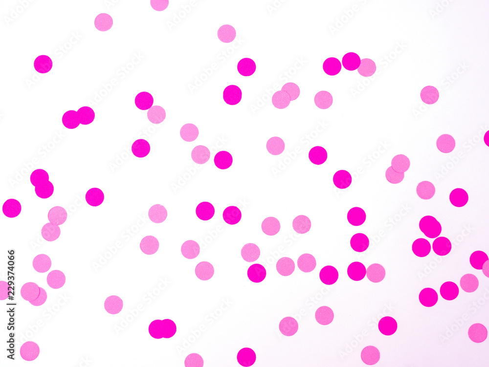 Pink confetti on white background. Pink background. Holiday background.