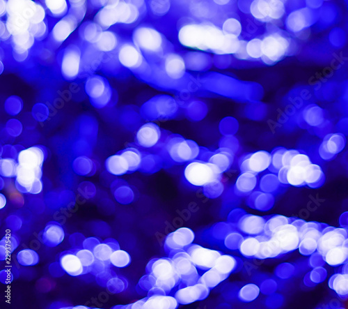 Blue Festive Christmas elegant abstract background with bokeh lights and stars. Valentine's Day. Glowing abstract black and purple abstract texture. Circular points. Raster image.