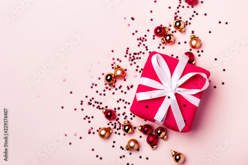 Christmas pastel background with gift and balls confetti