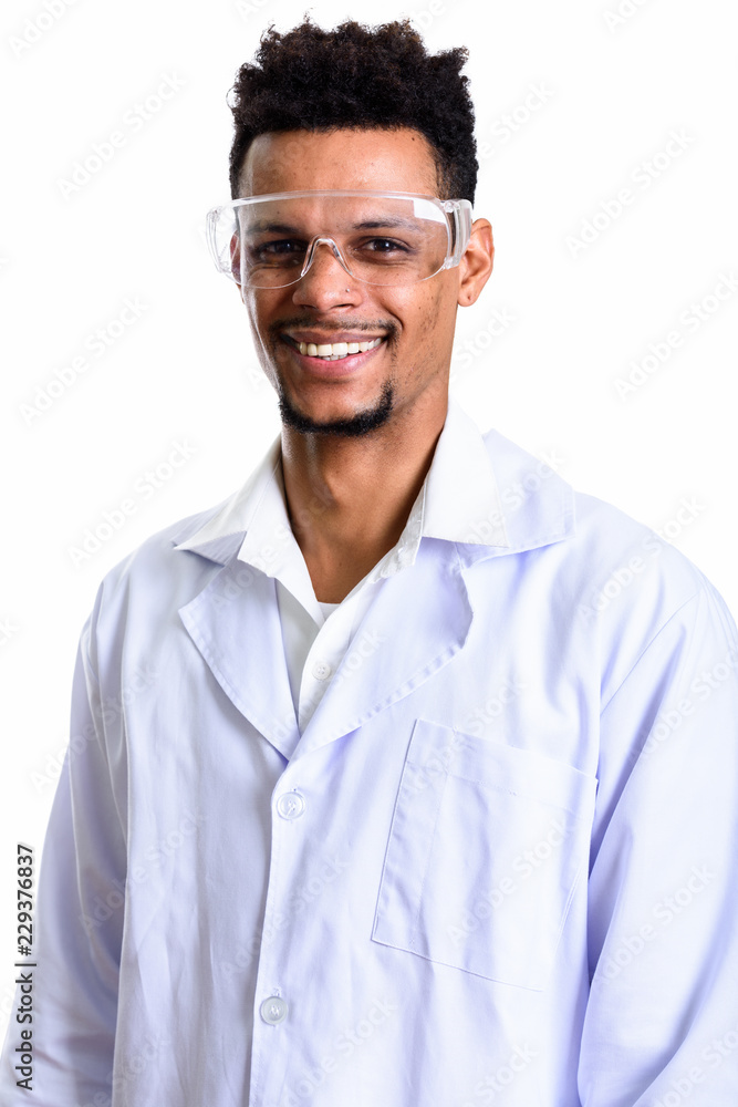 Studio shot of young happy African man doctor smiling while wear Studio shot of young happy African man doctor smiling while wear