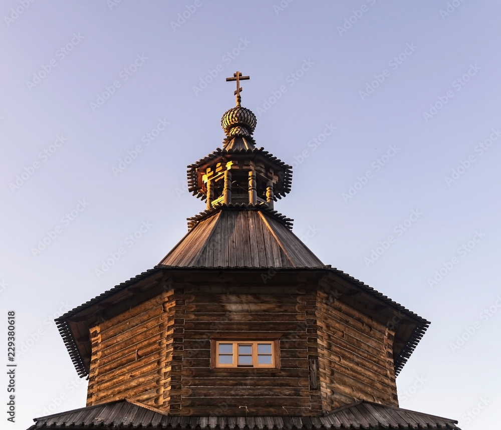Wooden church standing in the forest. Christian temple. Dome with a cross. Wooden church standing in the forest. Christian temple. Dome with a cross.
