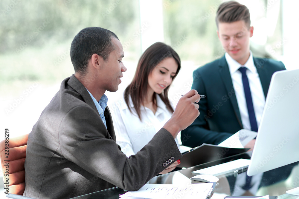 employees discussing new ideas in a modern office.t employees discussing new ideas in a modern office.t