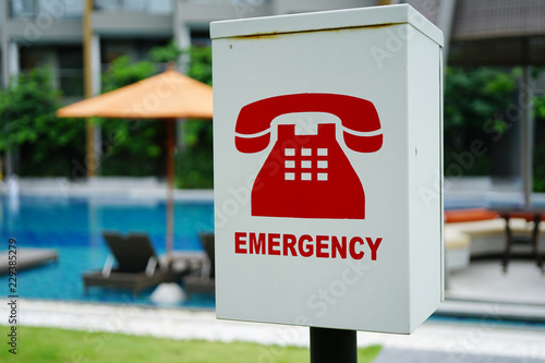 The red emergency phone box beside swimming pools