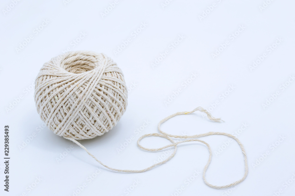 A ball of string with soft shadows on a white background. Copy space. A ball of string with soft shadows on a white background. Copy space.