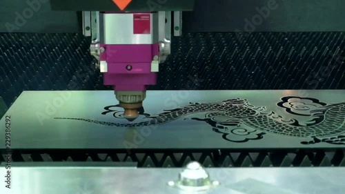 Close-up and inside of laser cutting machine, which is working in the cutting of steel plate according to the pattern set by the machine program, on industrial factory, industry 4.0