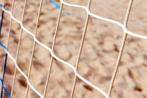 Beach volleyball net on sand background, close-up. Background