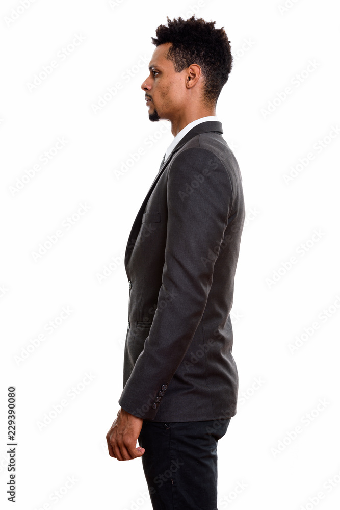 Profile view of young African businessman standing Profile view of young African businessman standing