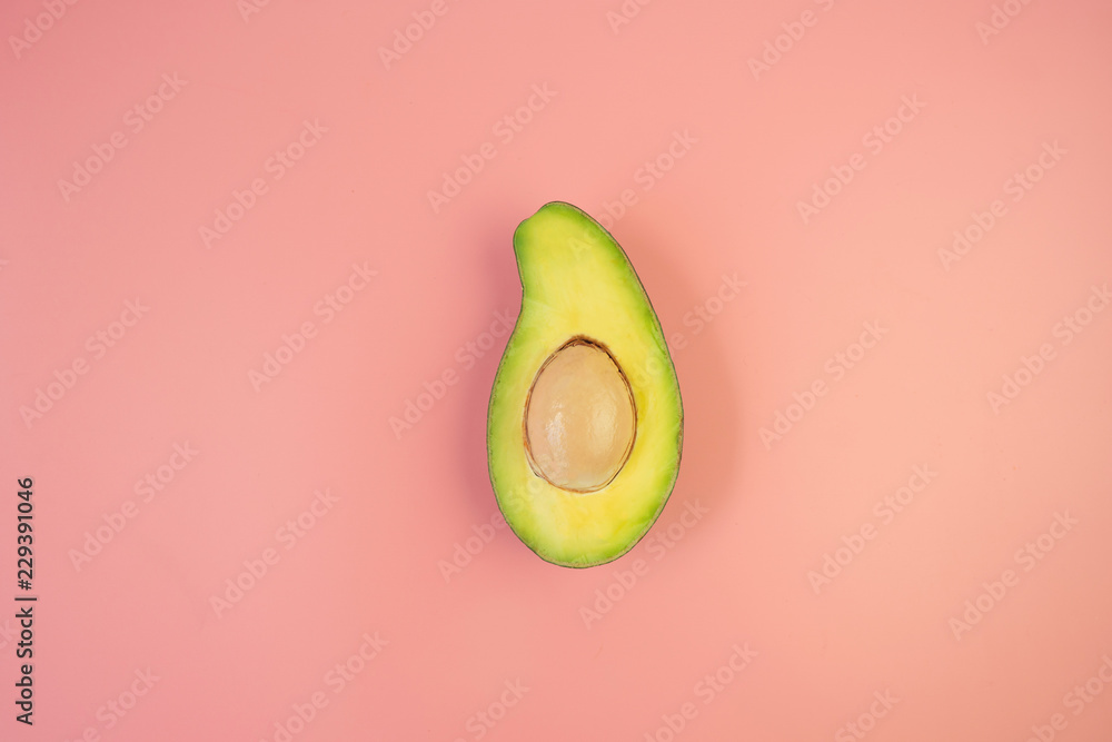 Top view of fresh avocado on pink background with copy space. Top view of fresh avocado on pink background with copy space.