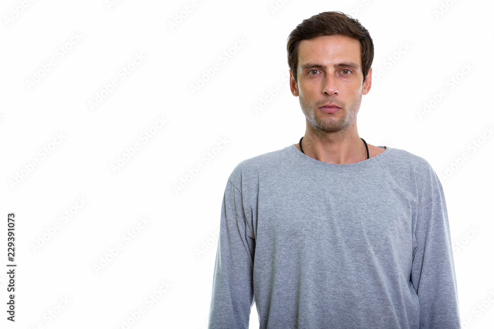 Studio shot of young handsome man looking at camera Studio shot of young handsome man looking at camera