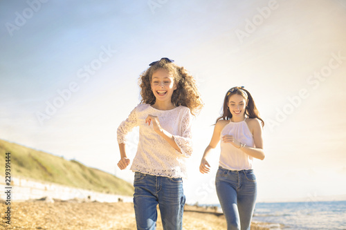 Mother and daughter playing at the beach
