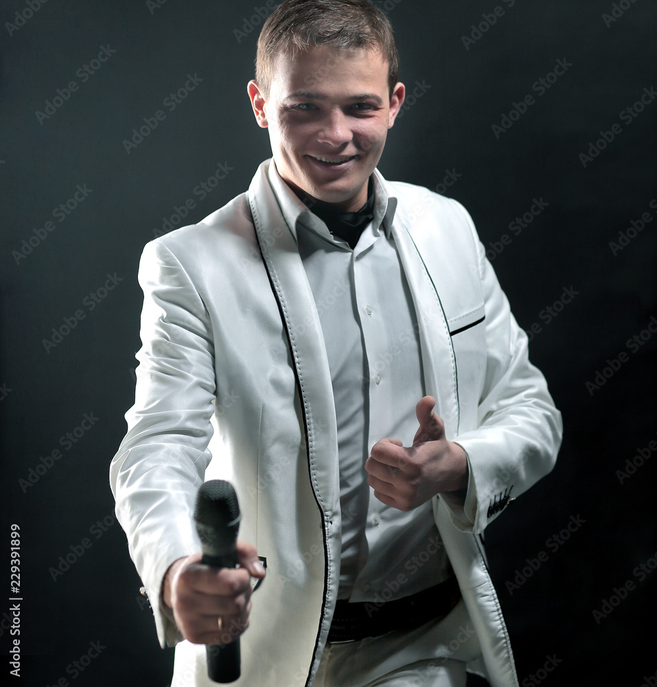Naklejka premium handsome male singer. isolated on black background