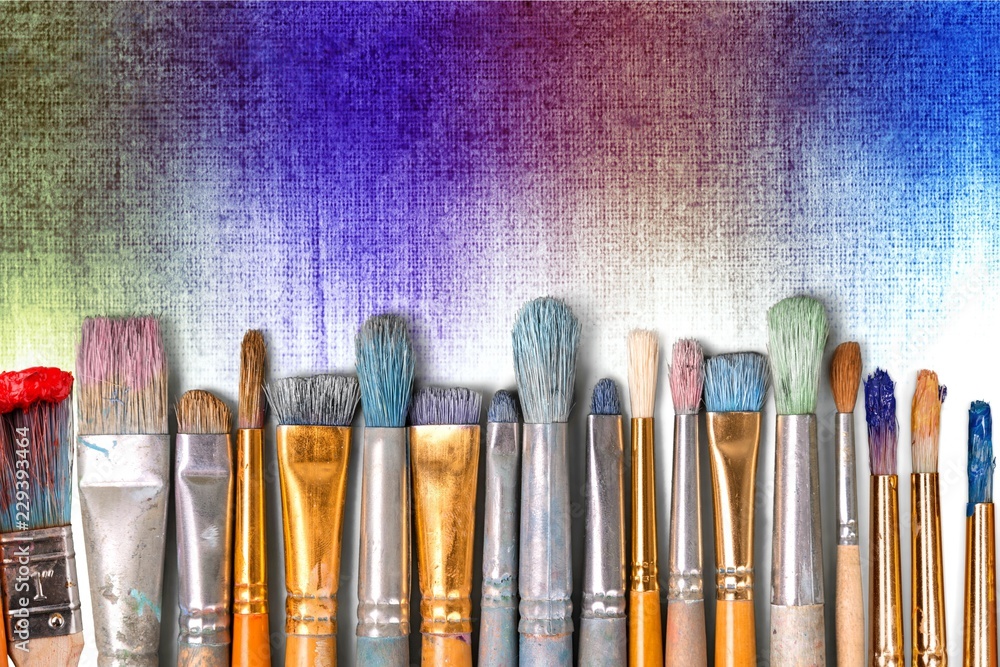Row of artist paint brushes  on background - obrazy, fototapety, plakaty 
