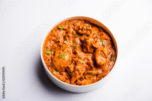 Murgh Makhani / Butter chicken tikka masala served with roti / Paratha and plain rice along with onion salad. selective focus