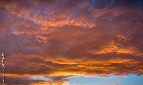 Vibrant orange and yellow sunset sky © Nigel