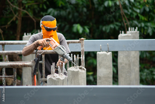 Workers are using Impact drill to drill concrete..