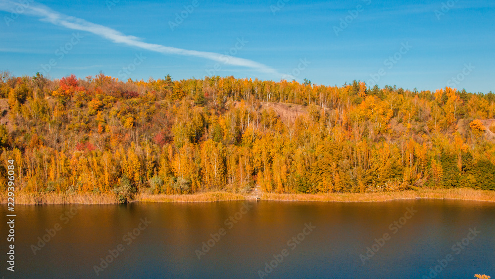 A beautiful landscape with an autumn forest and a river in a mountainous area A beautiful landscape with an autumn forest and a river in a mountainous area