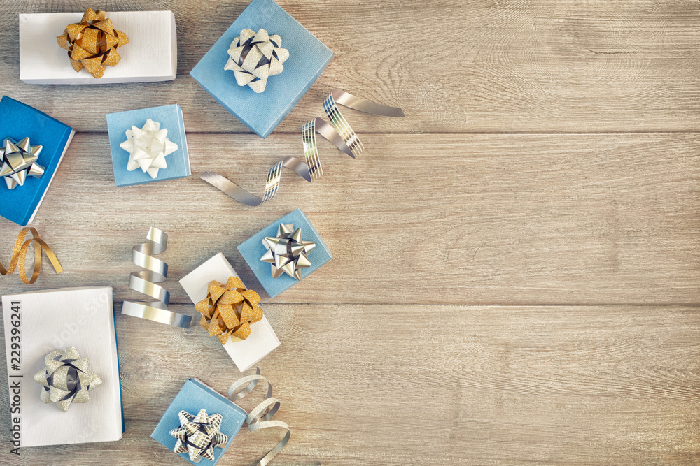 Christmas composition with copy space. Decorative ribbons, white and blue gift boxes with beautiful bows. Christmas composition with copy space. Decorative ribbons, white and blue gift boxes with beautiful bows.