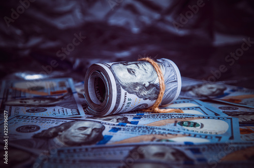 In the dark on broken money is a roll of dollars.