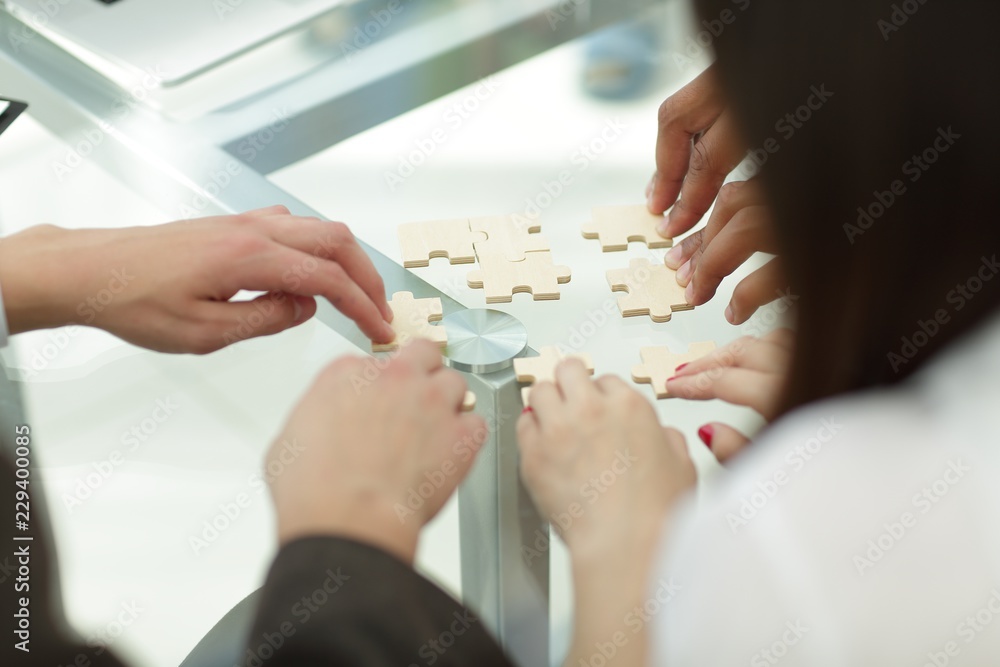 close up. business team assembling puzzle pieces.