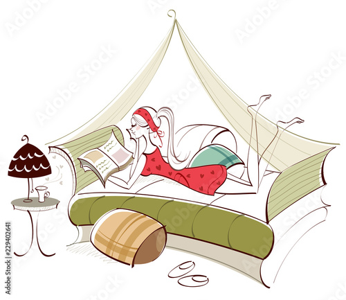 Side profile of a woman lying on the bed and reading a book