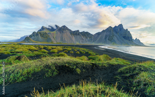 Vesturhorn Mountain in summer morning. Stokksnes, Iceland, Northern Europe, Scandinavia. Scenic beautiful nature landscape. Vibrant sunrise mountains landscape wallpaper. Popular tourist attraction. photo