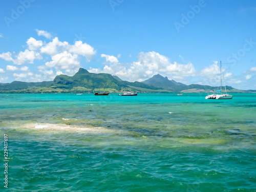 The tropical and transparent waters around the Ile aux Aigrettes, a small coral island declared a nature conservation site, during a boat trip. Mauritius, Indian Ocean.