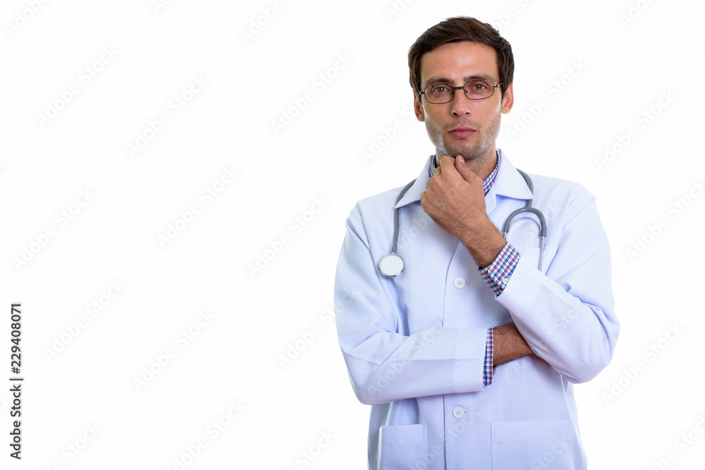Studio shot of young handsome man doctor thinking Studio shot of young handsome man doctor thinking